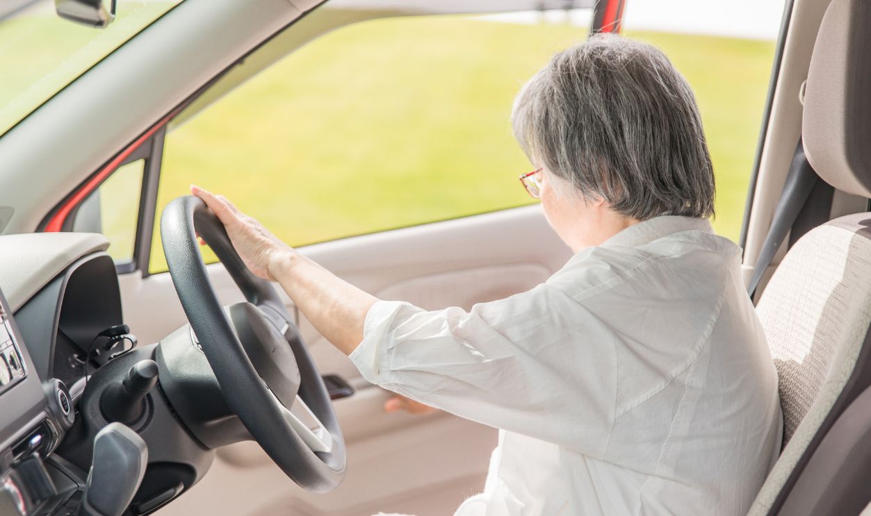 Shutterstock-2601624075, An elderly woman in the driver's seat of a car