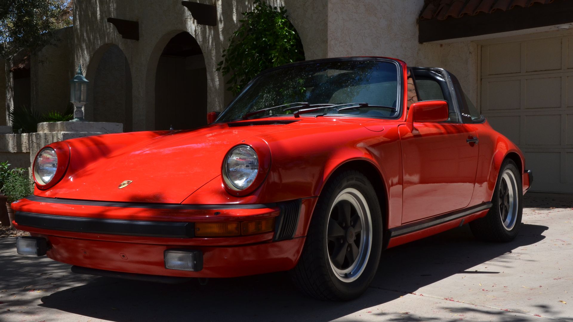 This is a red 1982 Porsche 911 SC targa.
