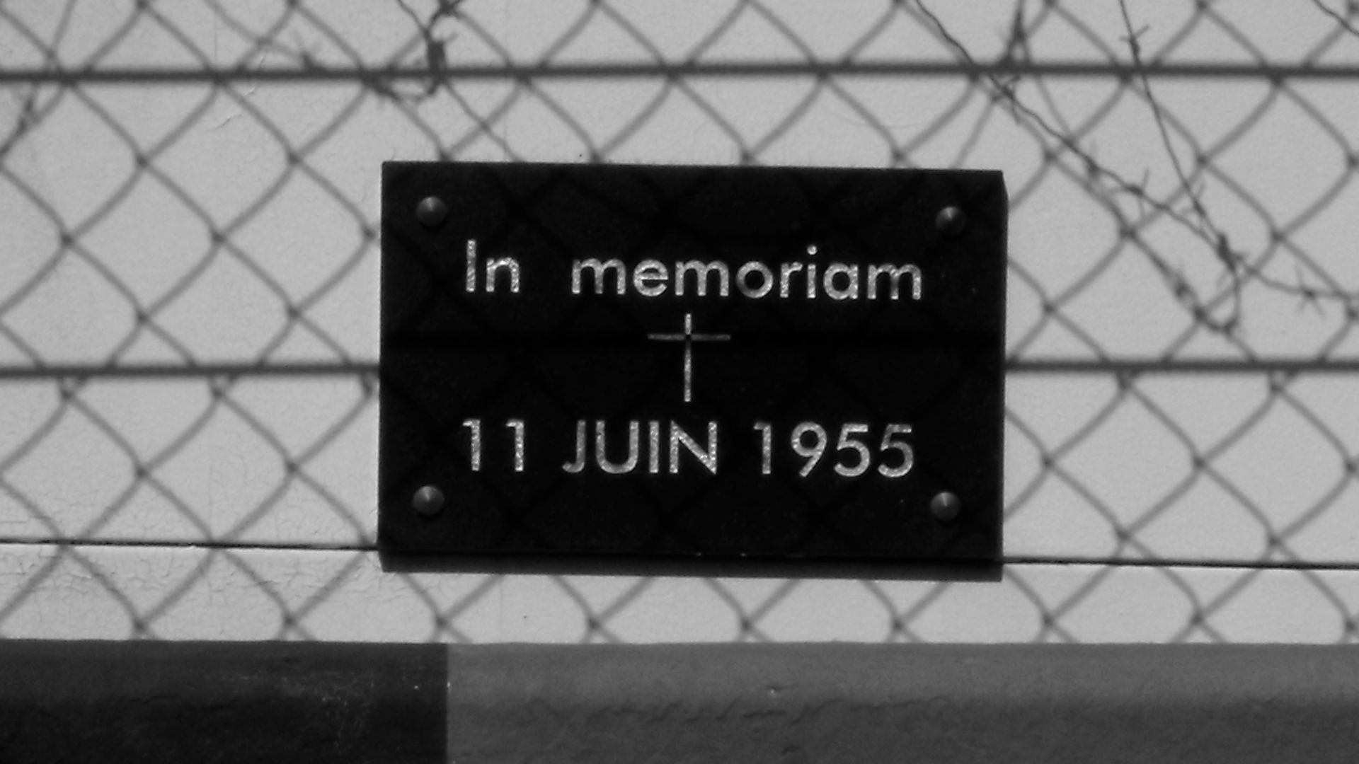 Phtotgraph of the memorial plaque at the site of the 1955 Le Mans disaster, taken by me at the 2009 Le Mans event from the pit lane on the other side of the pit straight
