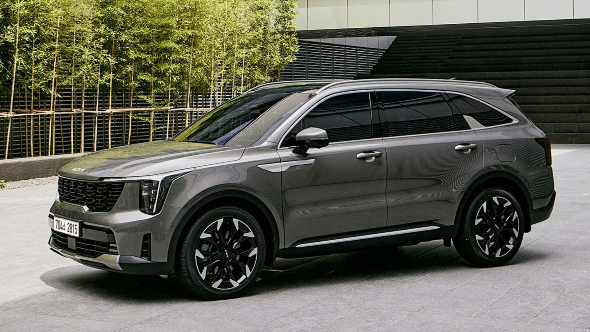 a grey suv parked in front of a building
