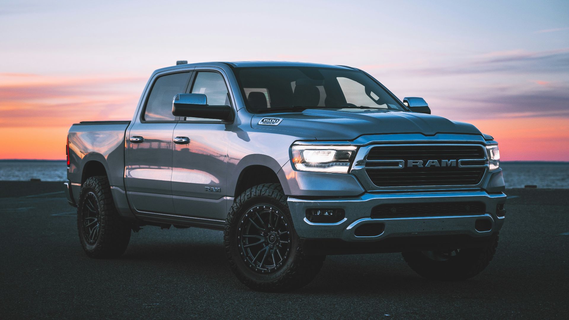 a silver ram truck parked in a parking lot