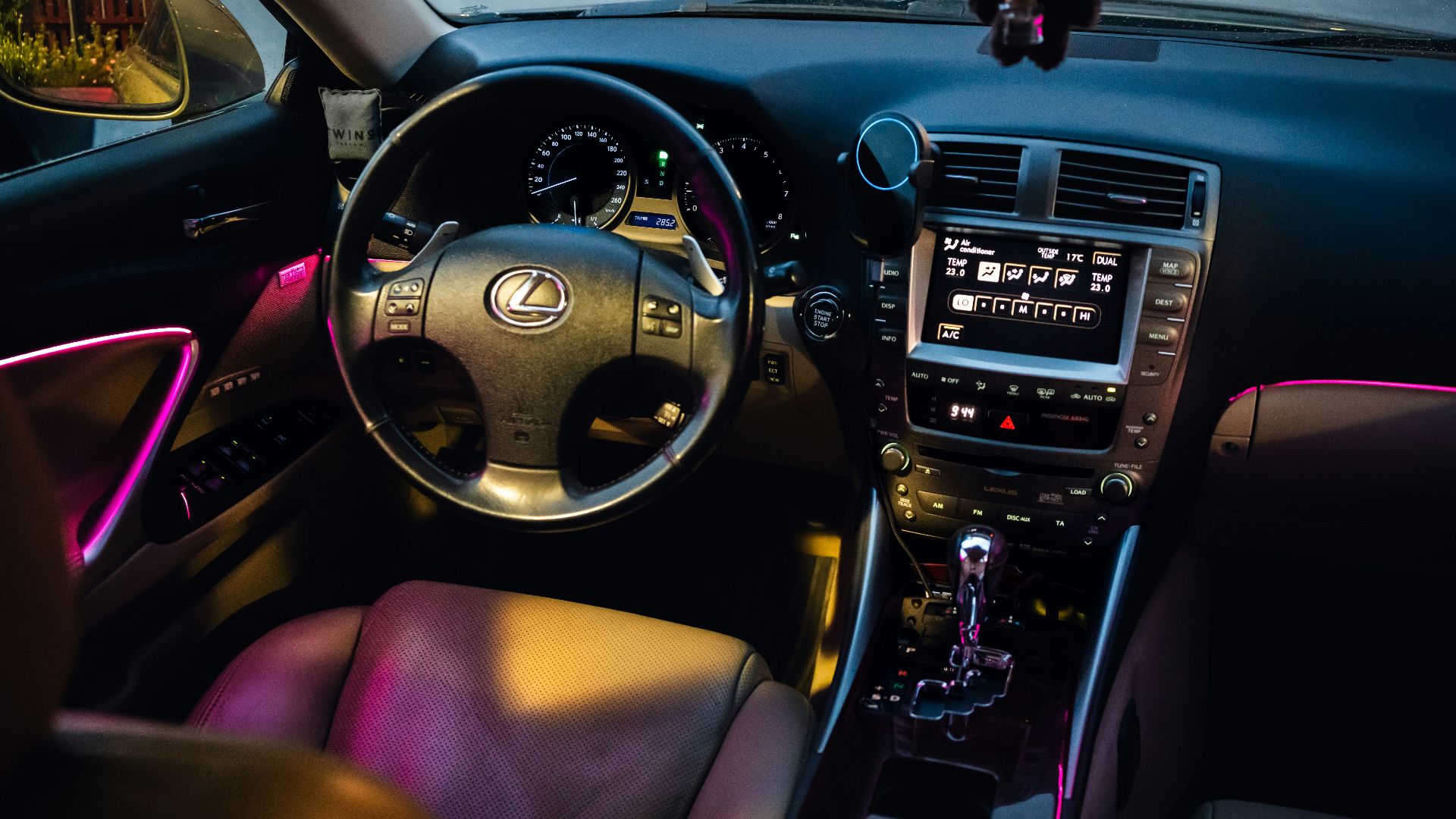Lexus car interior with pink ambient lighting.