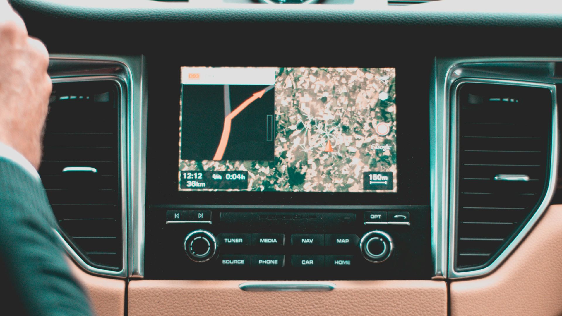 person holding steering wheel