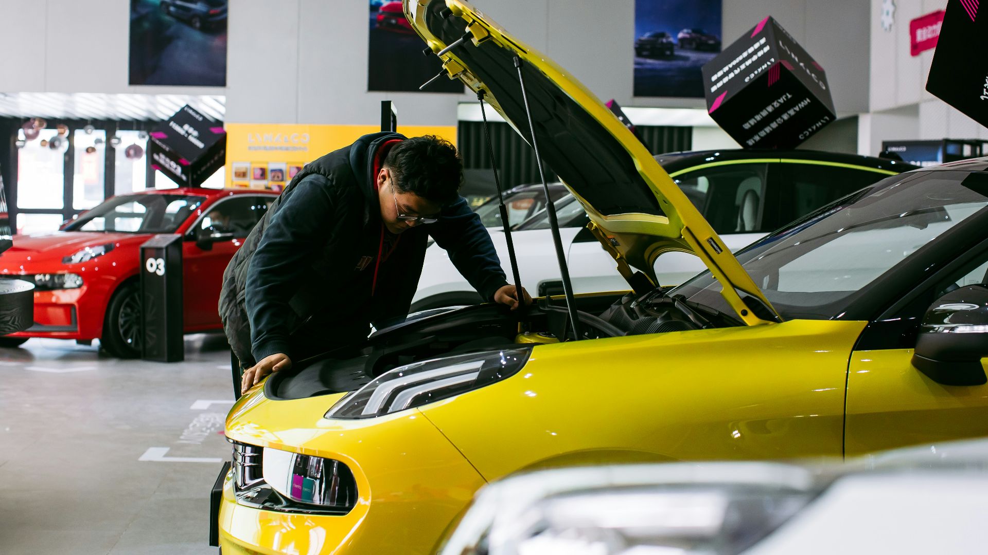 man in black jacket and black pants riding yellow car