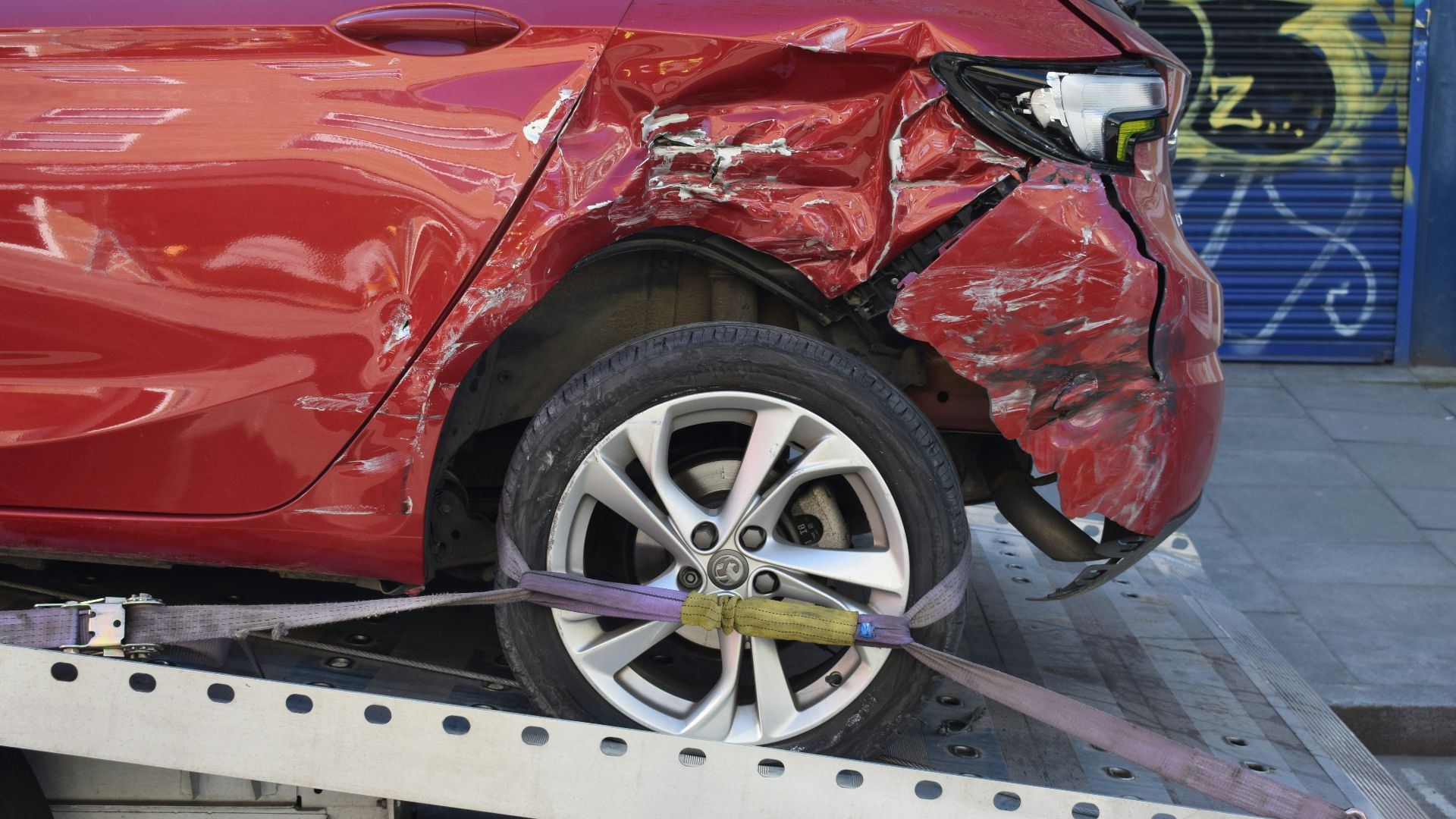a red car is on a flatbed tow truck