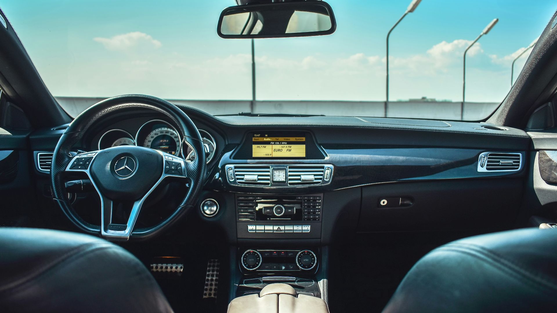 black Mercedes-Benz vehicle steering wheel