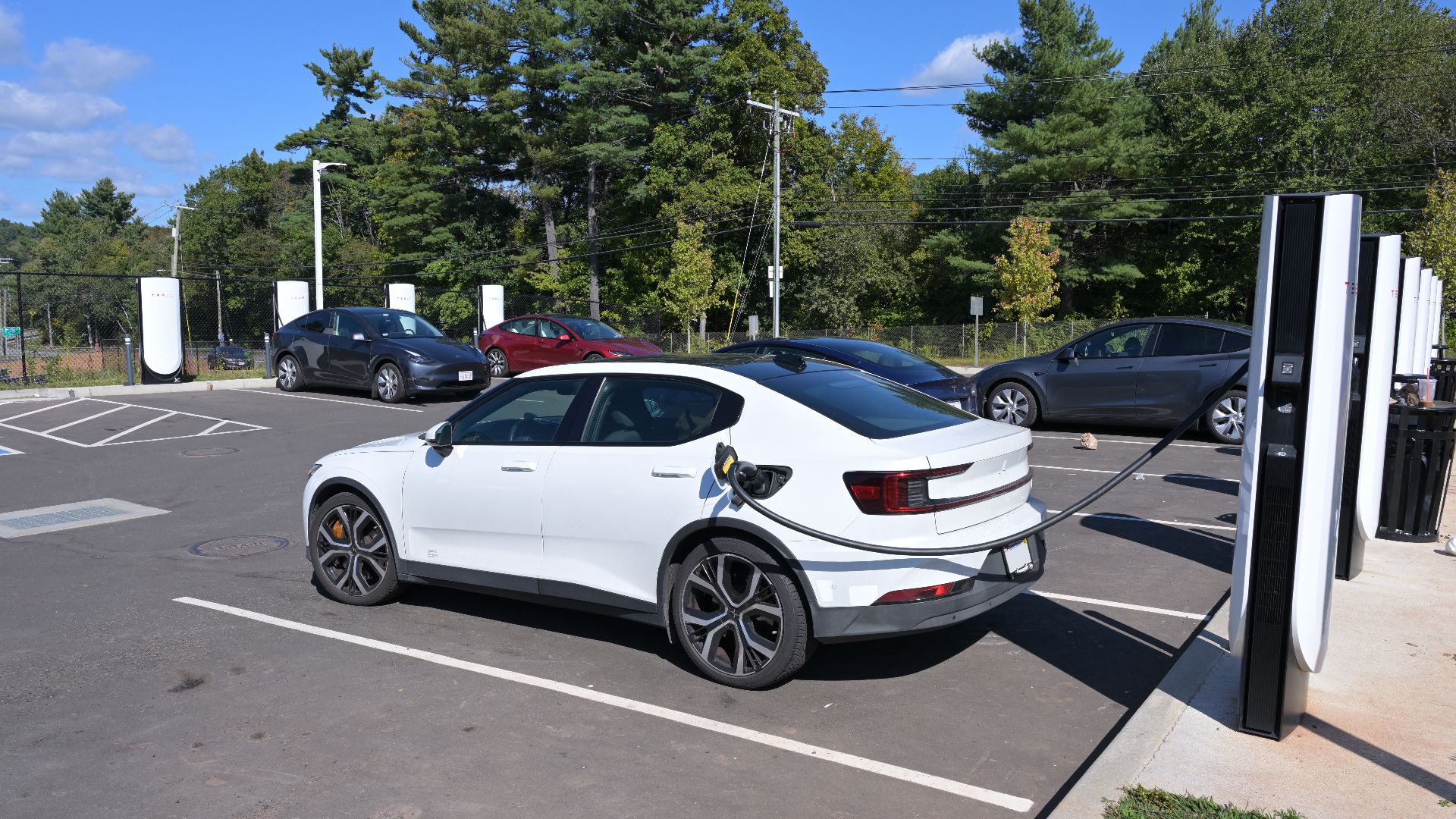 A 2021 Polestar 2 charges at a Tesla Supercharger in Willington, Connecticut