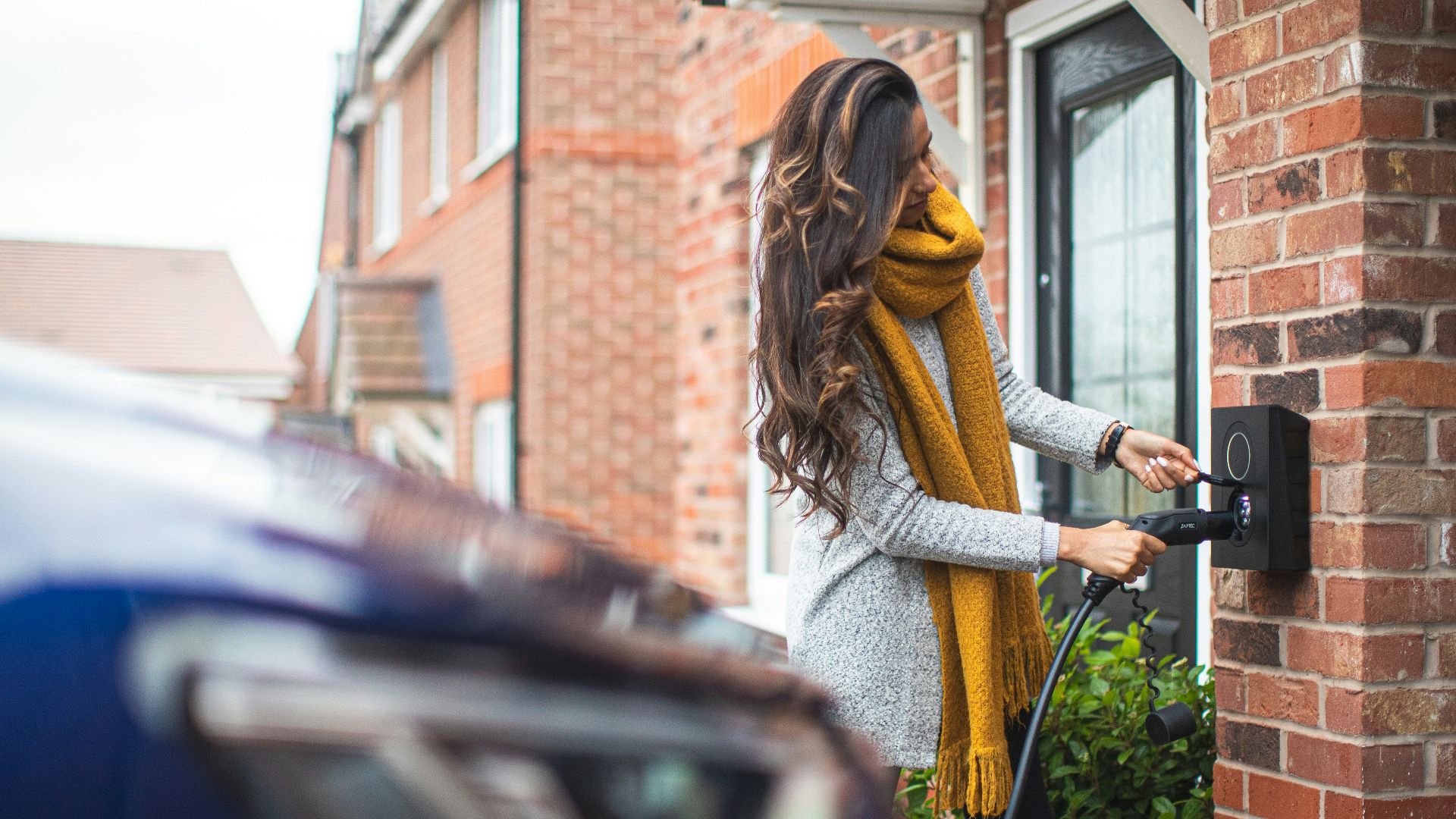 a woman is opening the door of her house