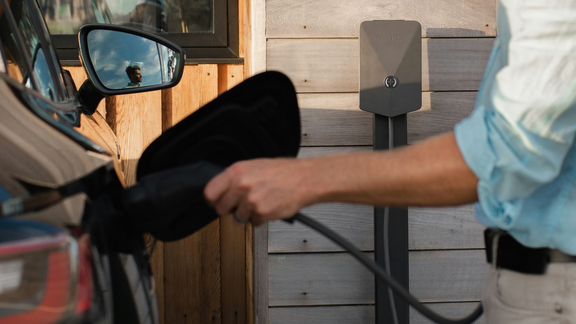a man pumping gas into his car at a gas station