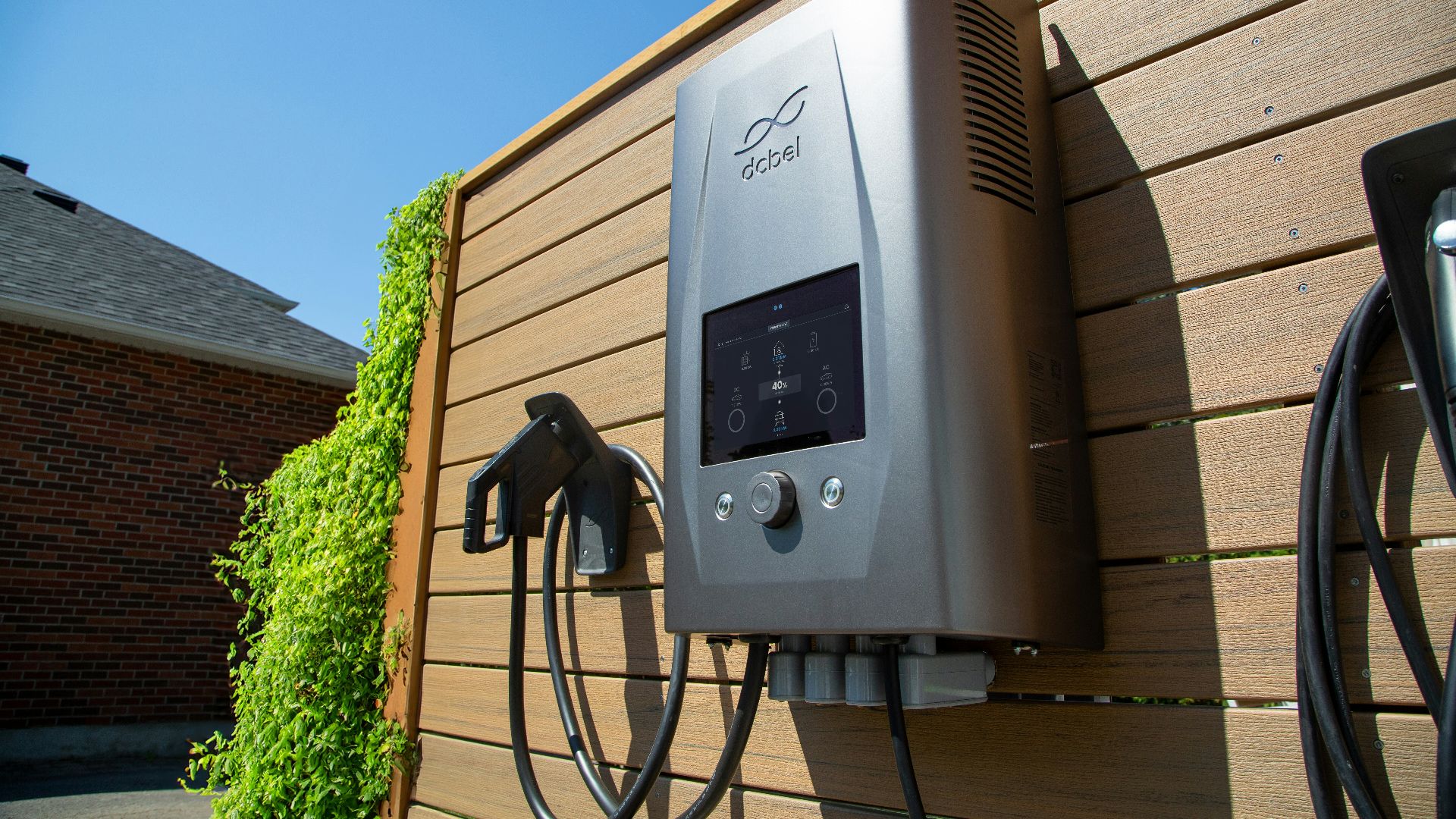 Electric car charger mounted on a wooden wall.