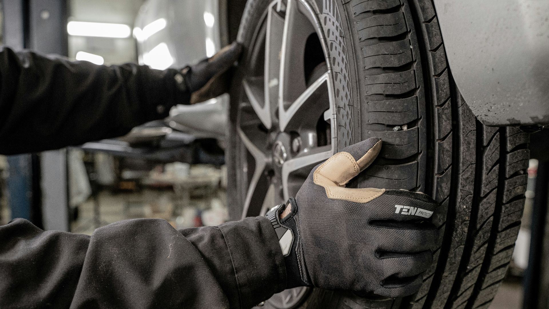 a man working on a tire in a garage