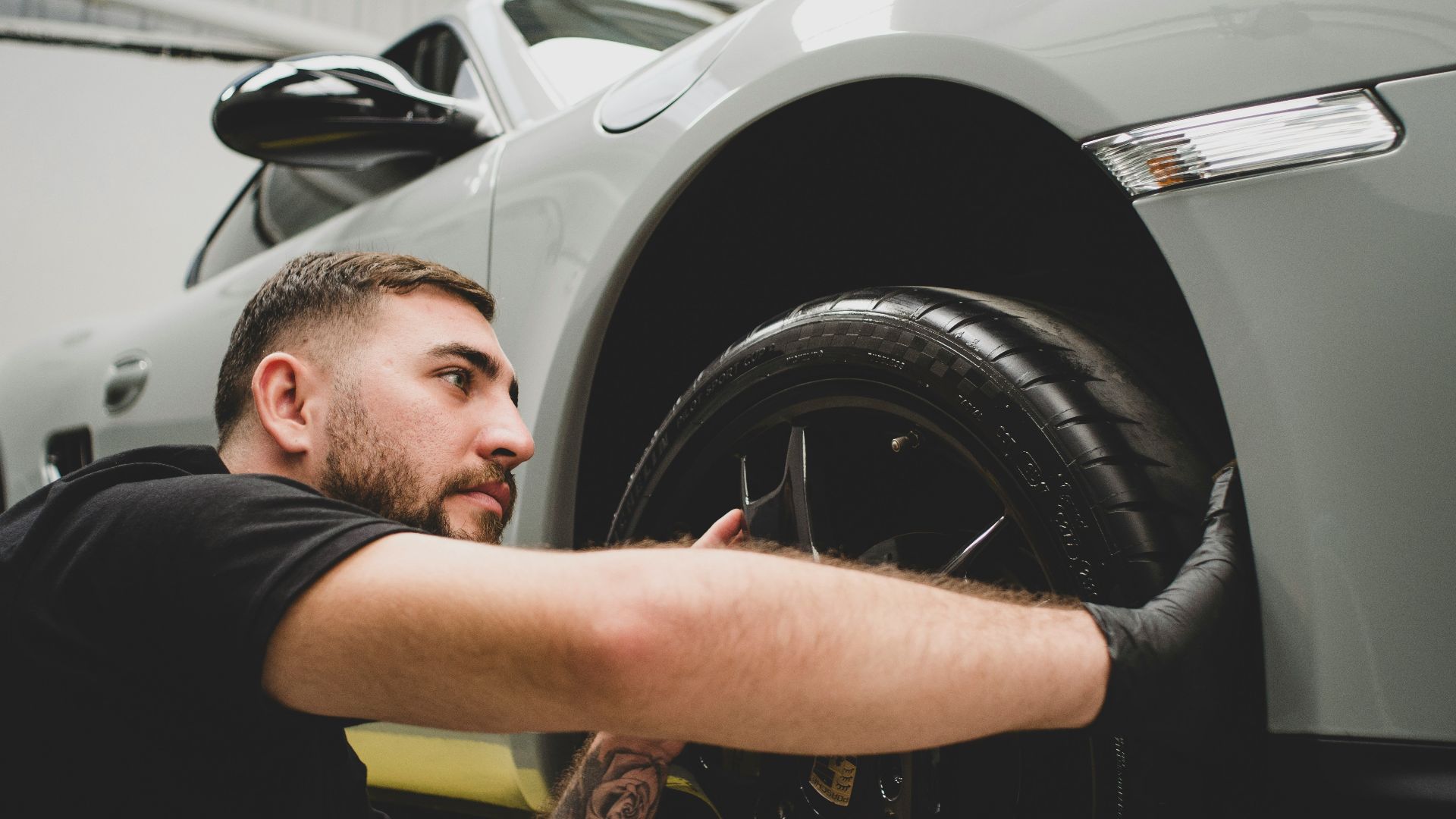 a man working on a car in a garage