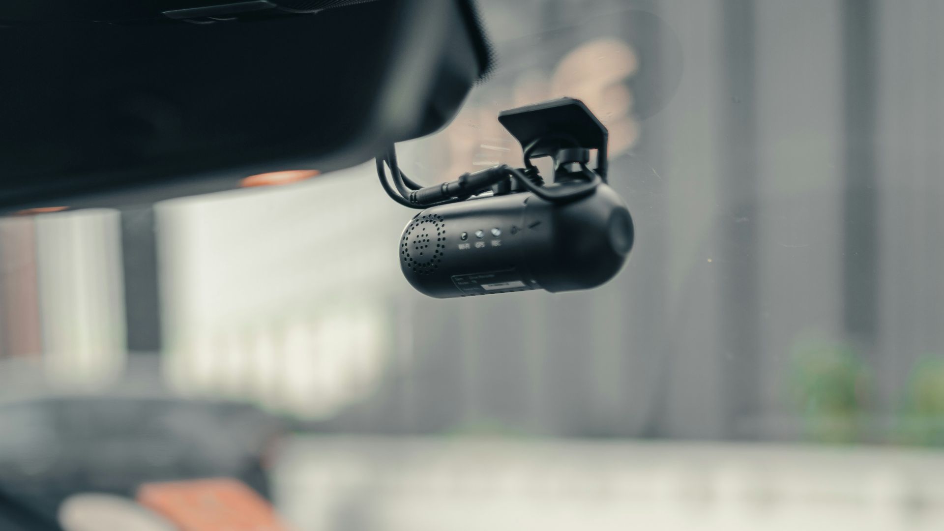 black iphone 4 on car dashboard