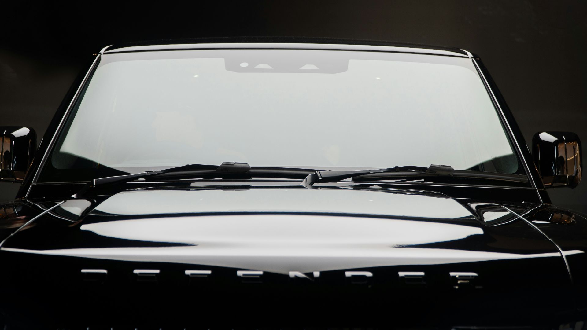 A black suv's front end is depicted