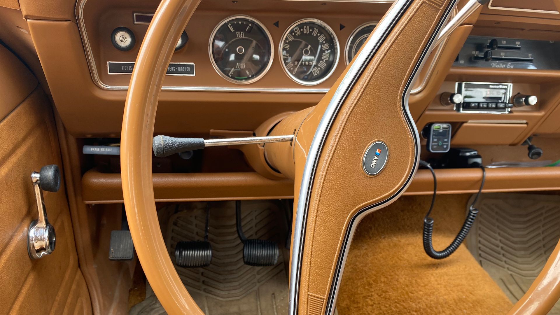 1974 AMC Hornet, a compact-sized four-door sedan made by American Motors Corporation. This is the base model finished in Ginger Tan with matching standard bench seat interior and fabric upholstery. It has the standard manual three-speed transmission with
