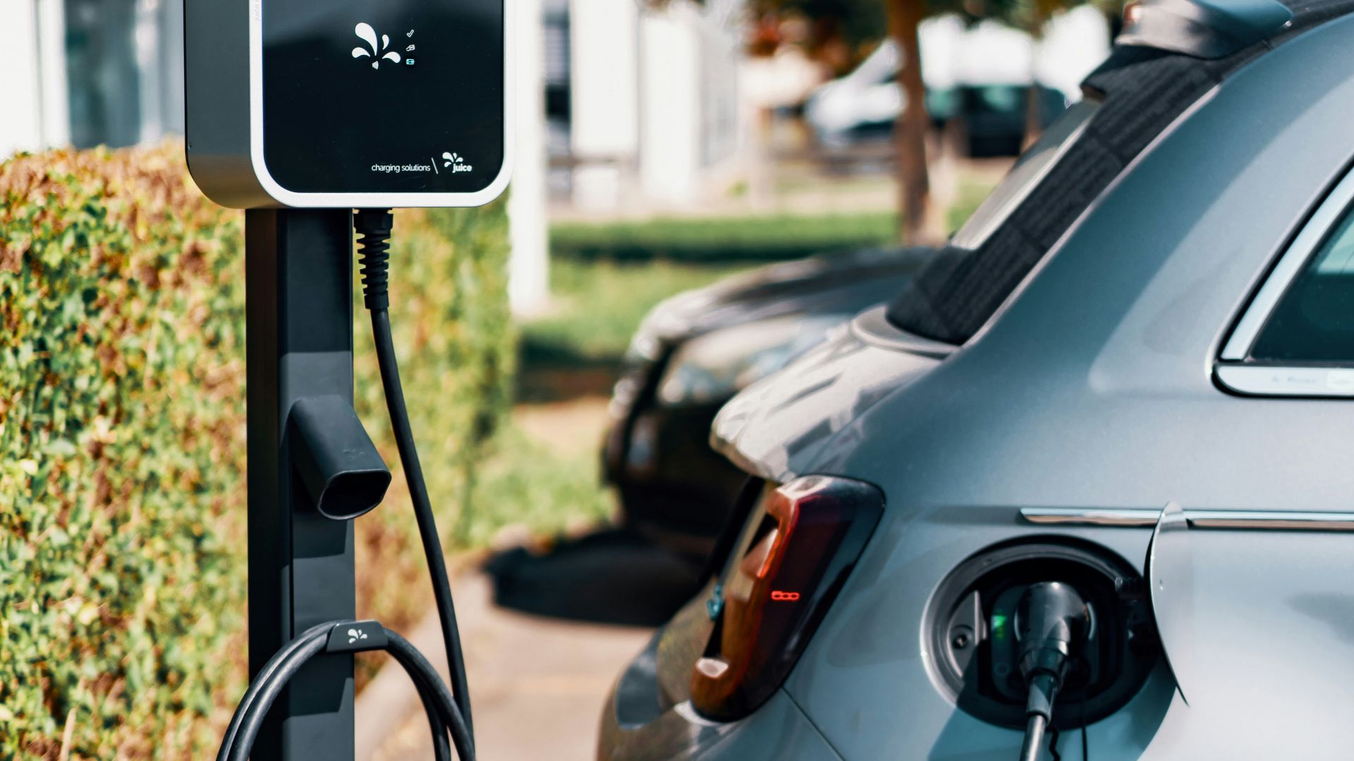 An electric car plugged in to a charging station
