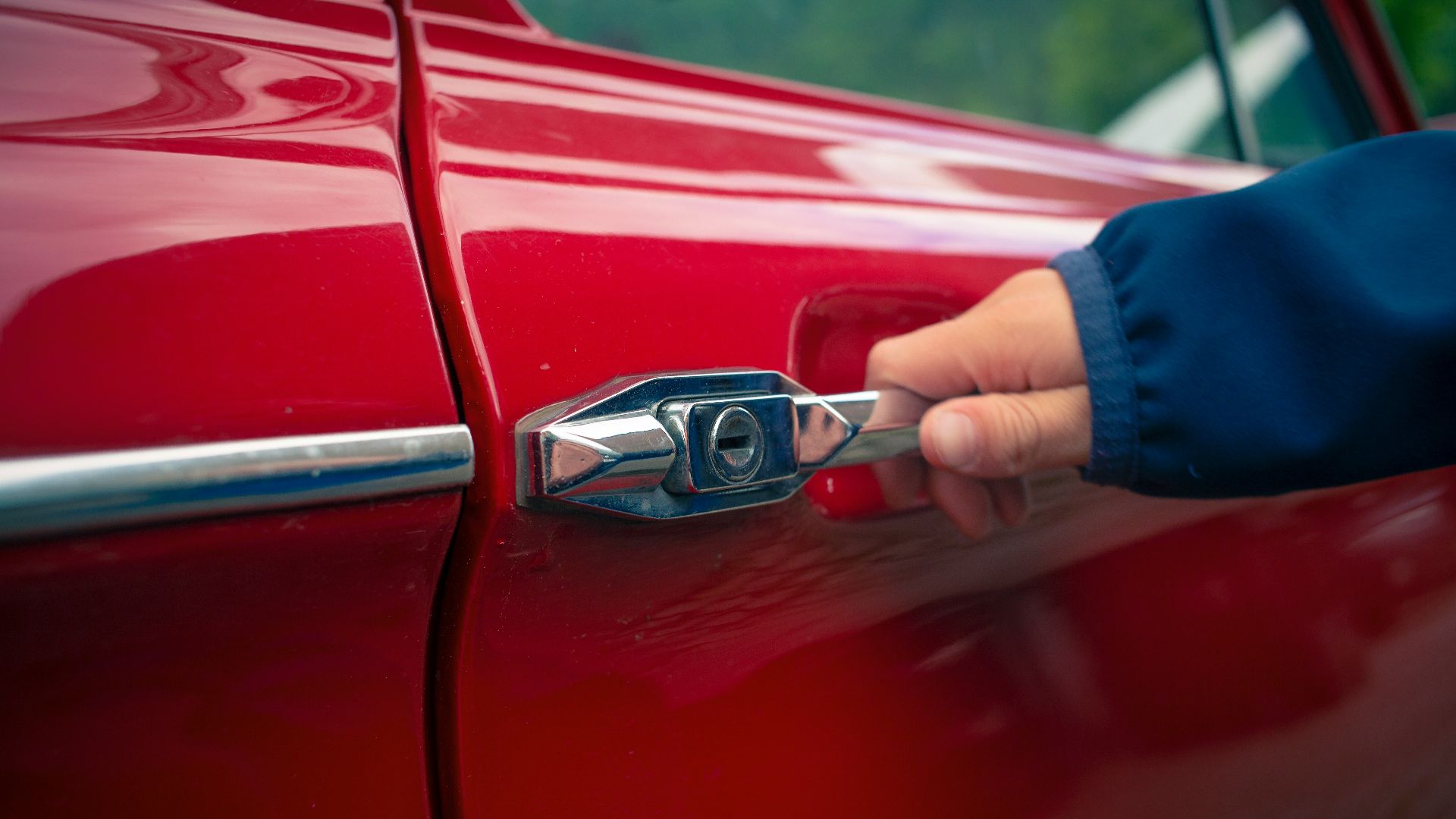 person holding car door