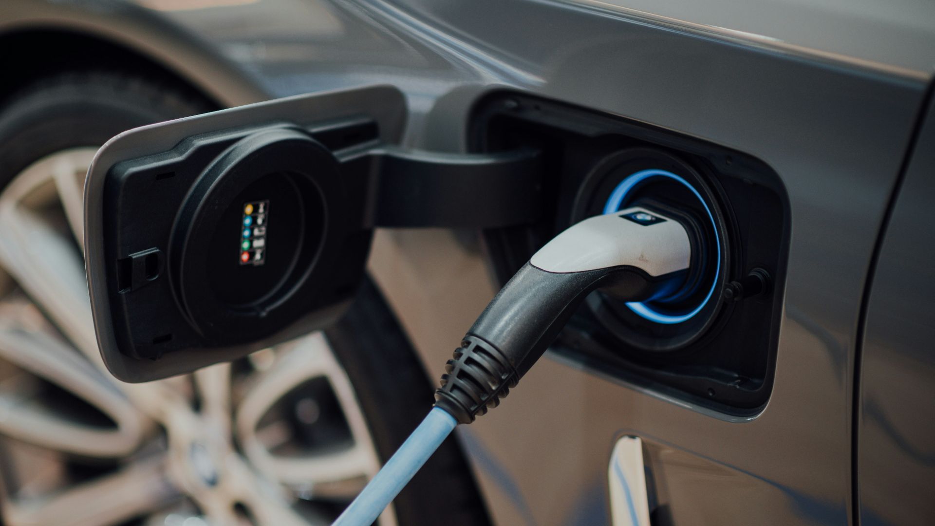 electric vehicle charging cable plugged into car