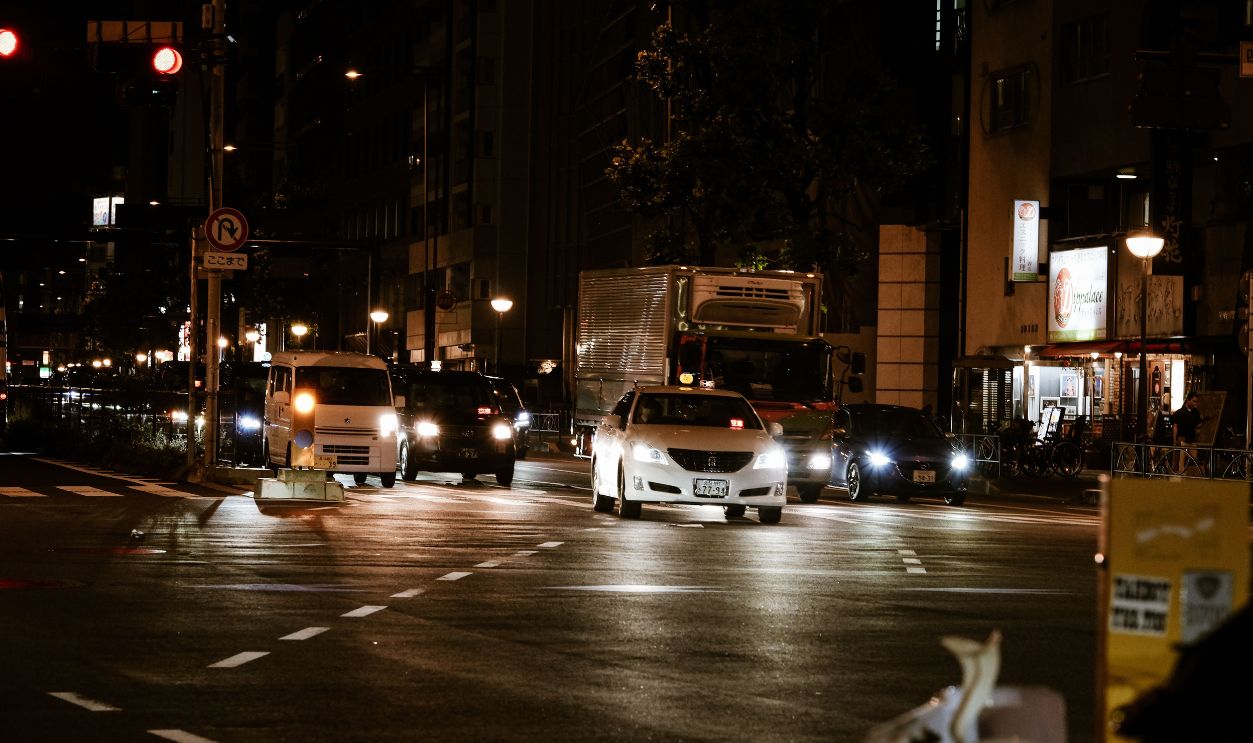 Busy night traffic scene in Shinjuku, Tokyo capturing cars and a vibrant city atmosphere