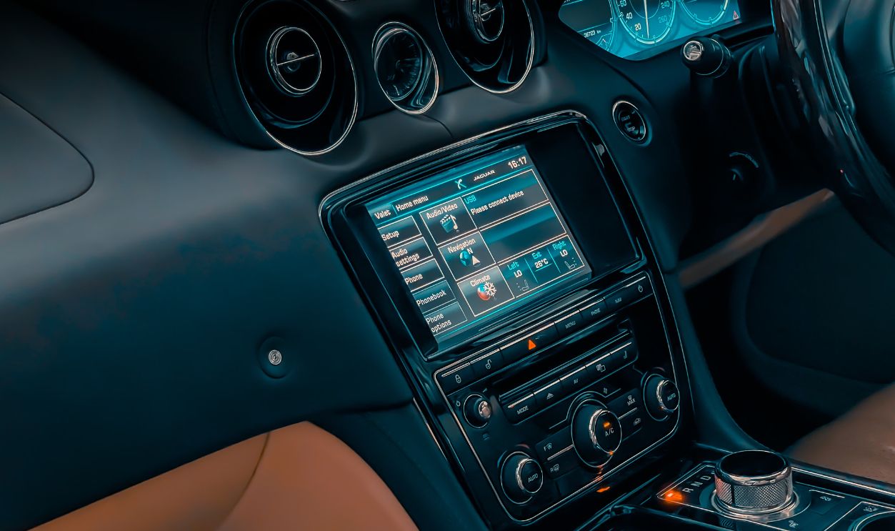 Close-up of luxury car interior showcasing dashboard, controls, and touchscreen display