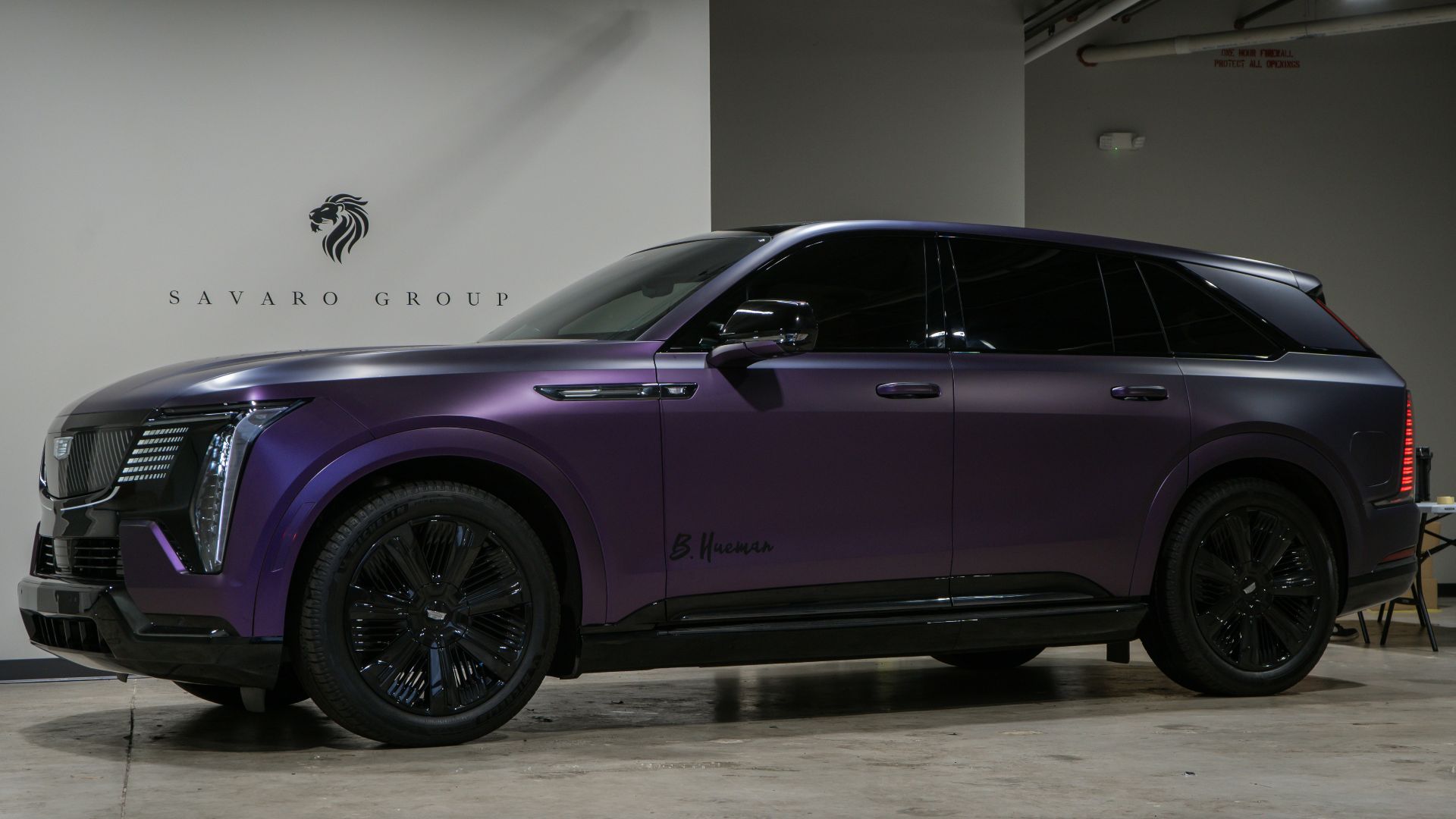 A purple cadillac suv parked indoors