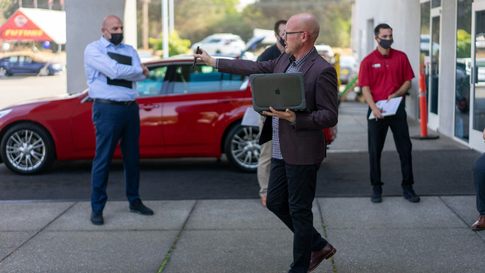 man in white dress shirt and black pants holding ipad