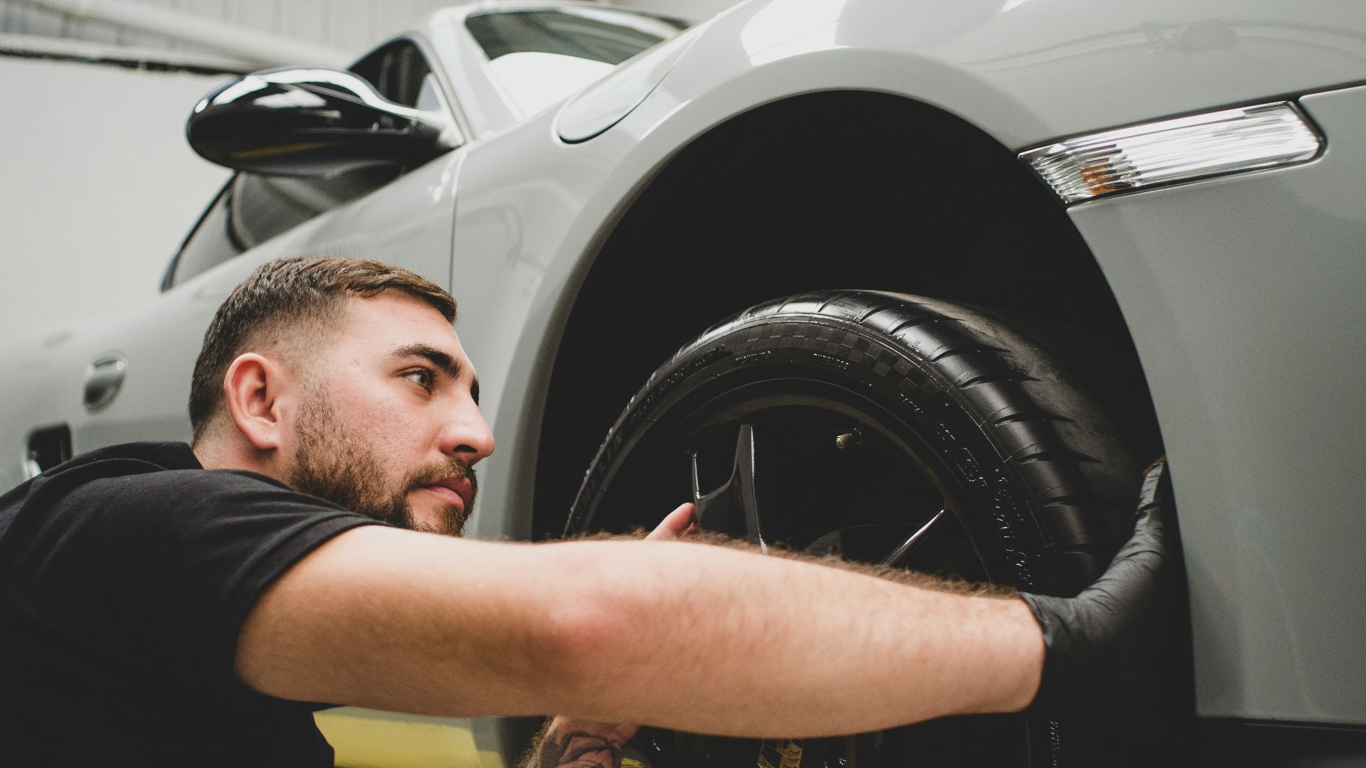 a man working on a car in a garage