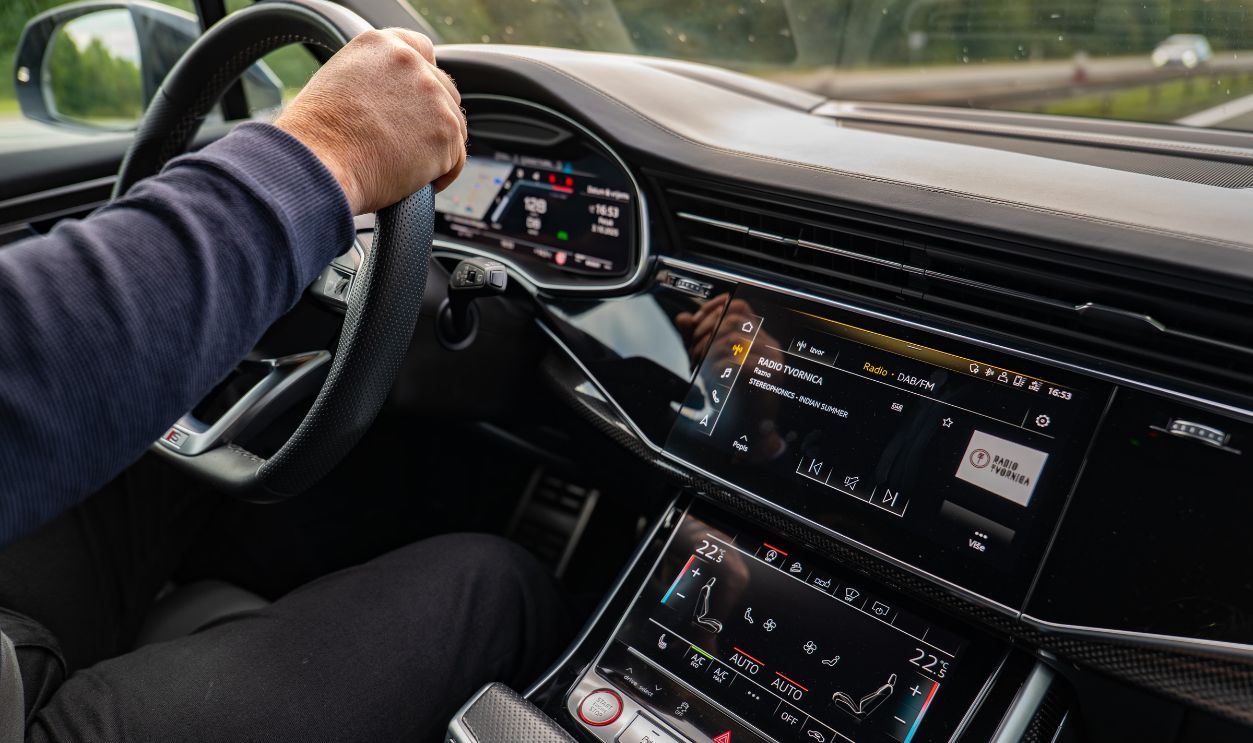 Interior view of a modern car being driven in Osijek, highlighting the dashboard and entertainment system