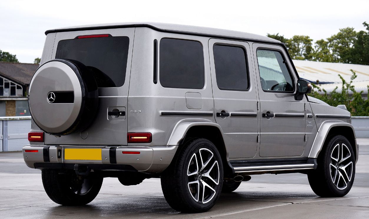 High-end grey SUV with distinctive alloy wheels showcased in an outdoor setting