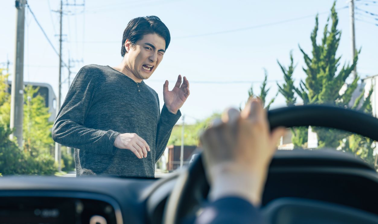 2533175885 - A scene from the driver's seat of a man nearly being hit by a car