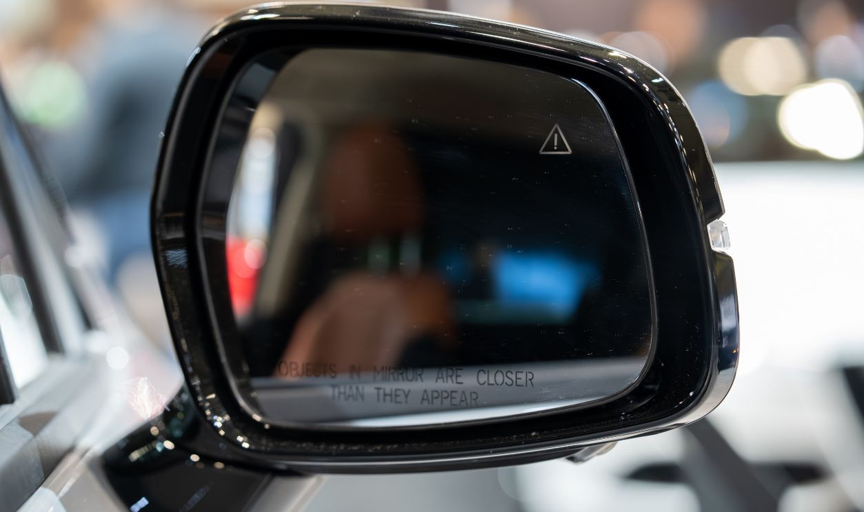 2747825619 - Close up of car side mirror with blind spot warning icon.