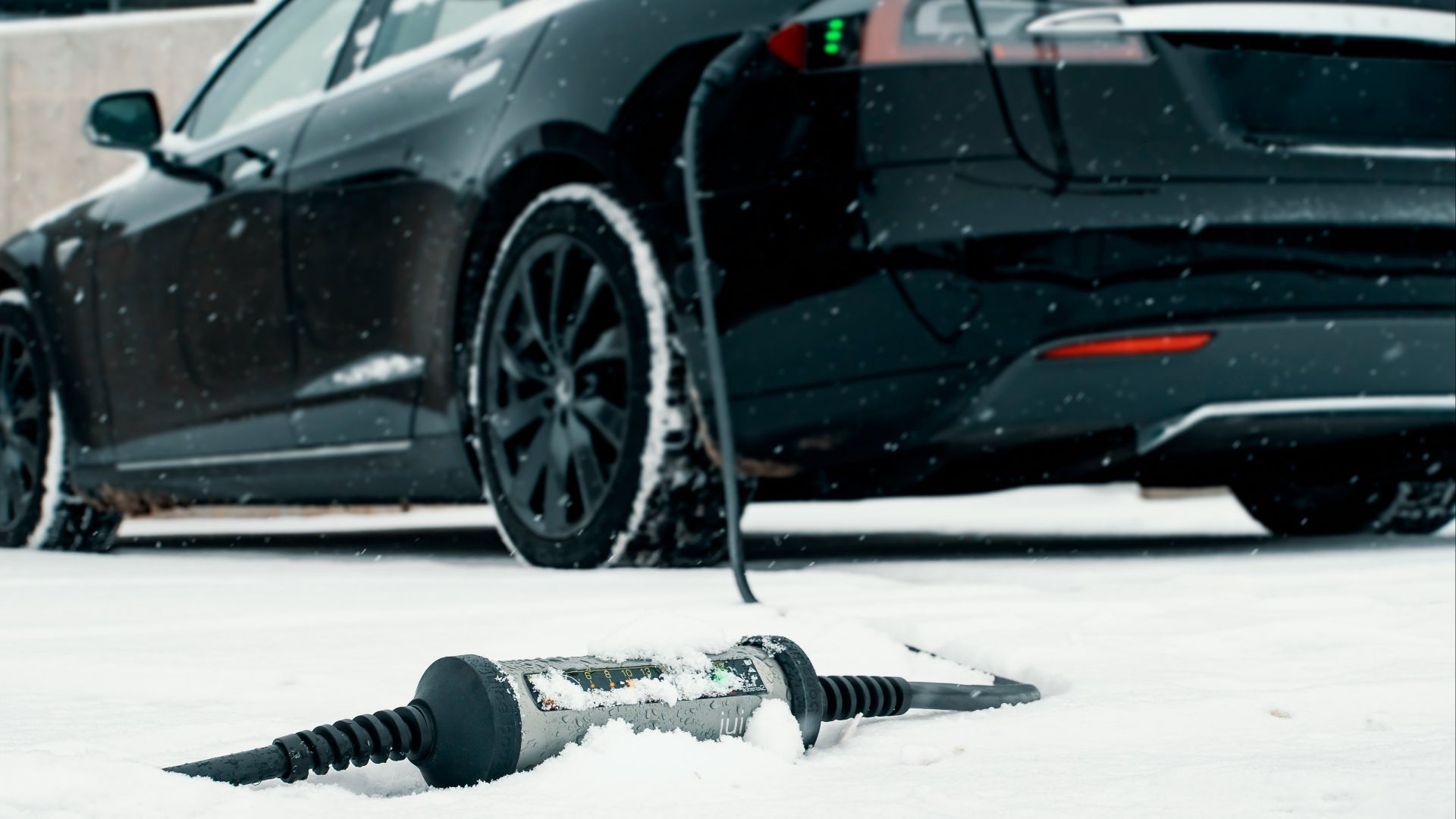 a car is parked in the snow next to a screwdriver