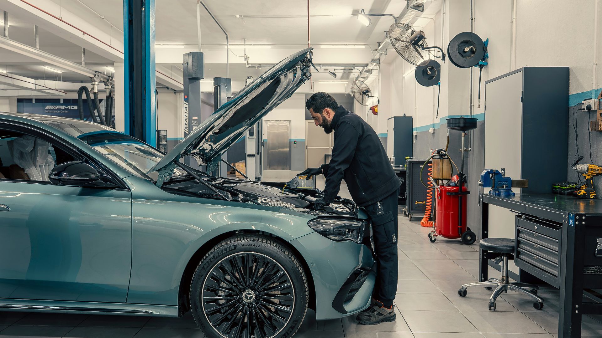 Mechanic working on a car engine in a workshop