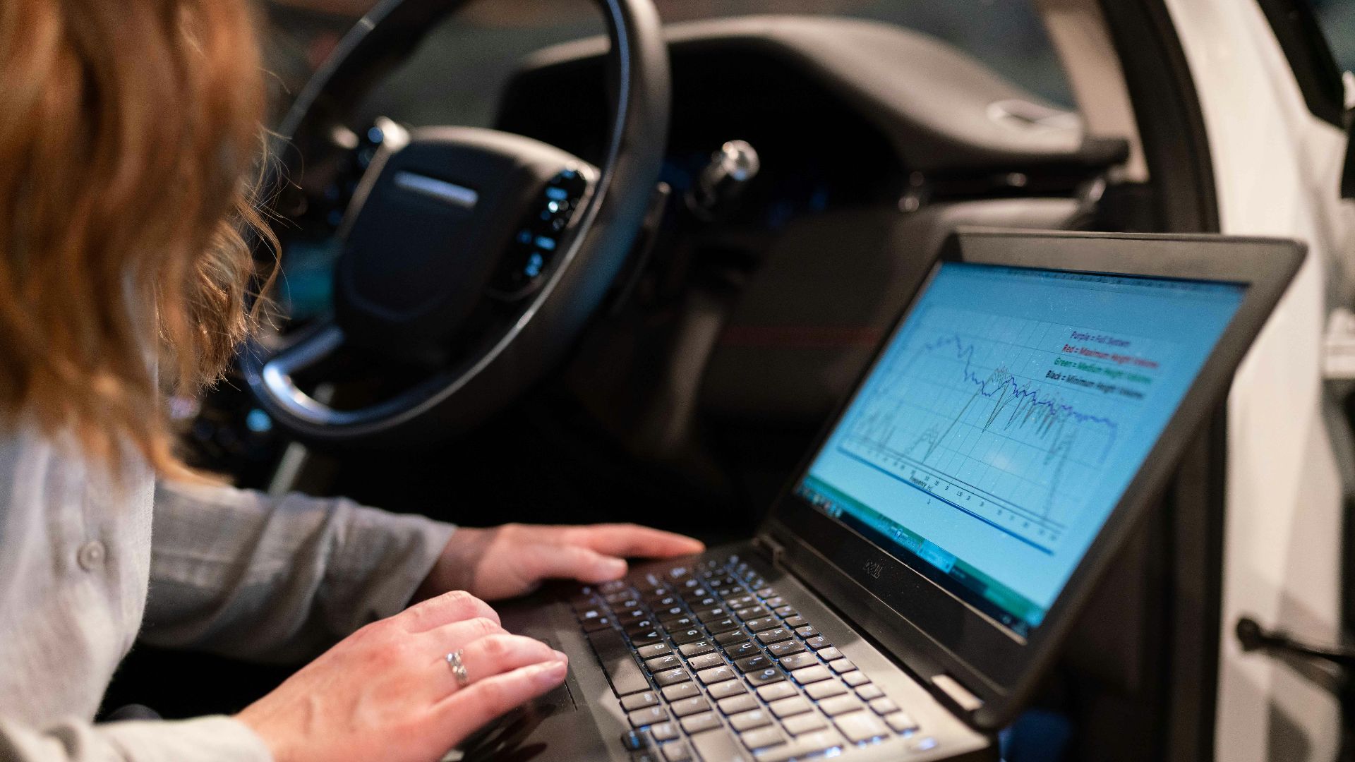 woman in gray long sleeve shirt using black laptop computer
