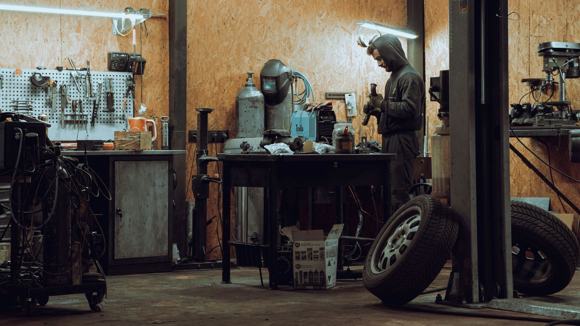 a man working on a machine in a garage