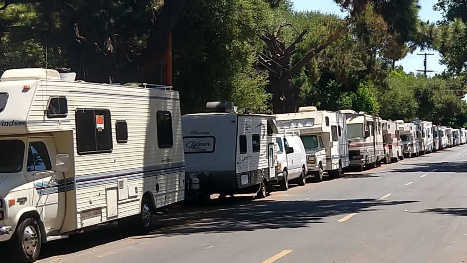 A line of RV campers being used as residences on a city street in Mountain View, CA
Photo taken in August 2019