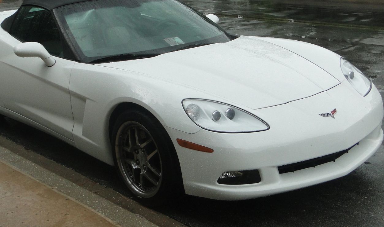 Orlando, United States of America - June 15th 2009 - A stationary white Chevrolet Corvette Convertible model posing for the picture in a parking lot, front side view. 