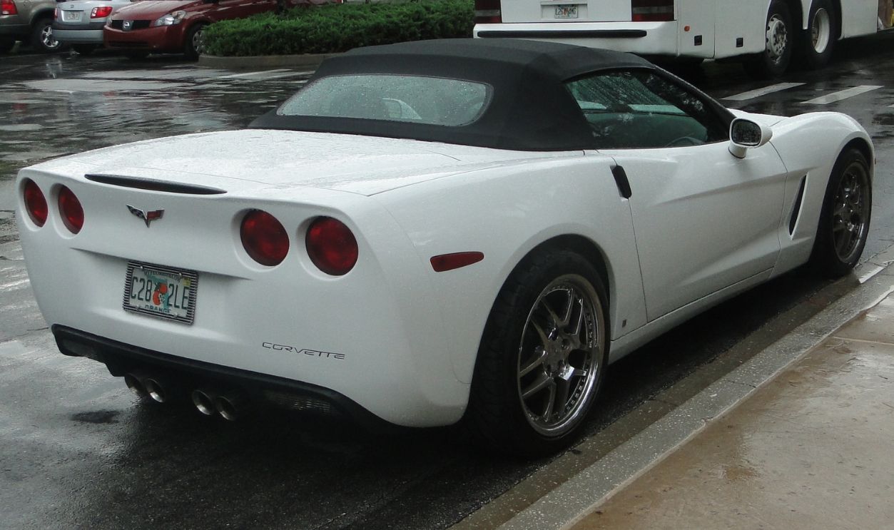 Orlando, United States of America - June 15th 2009 - A stationary white Chevrolet Corvette Convertible model posing for the picture in a parking lot, rear side view.