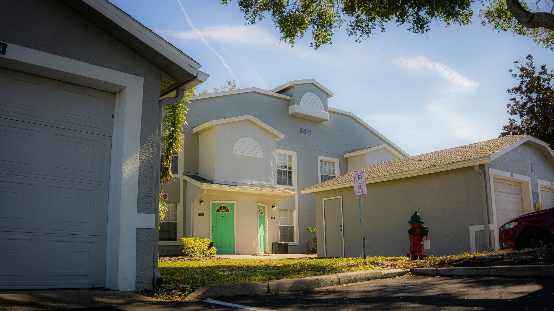 Apartment buildings with garages and green doors
