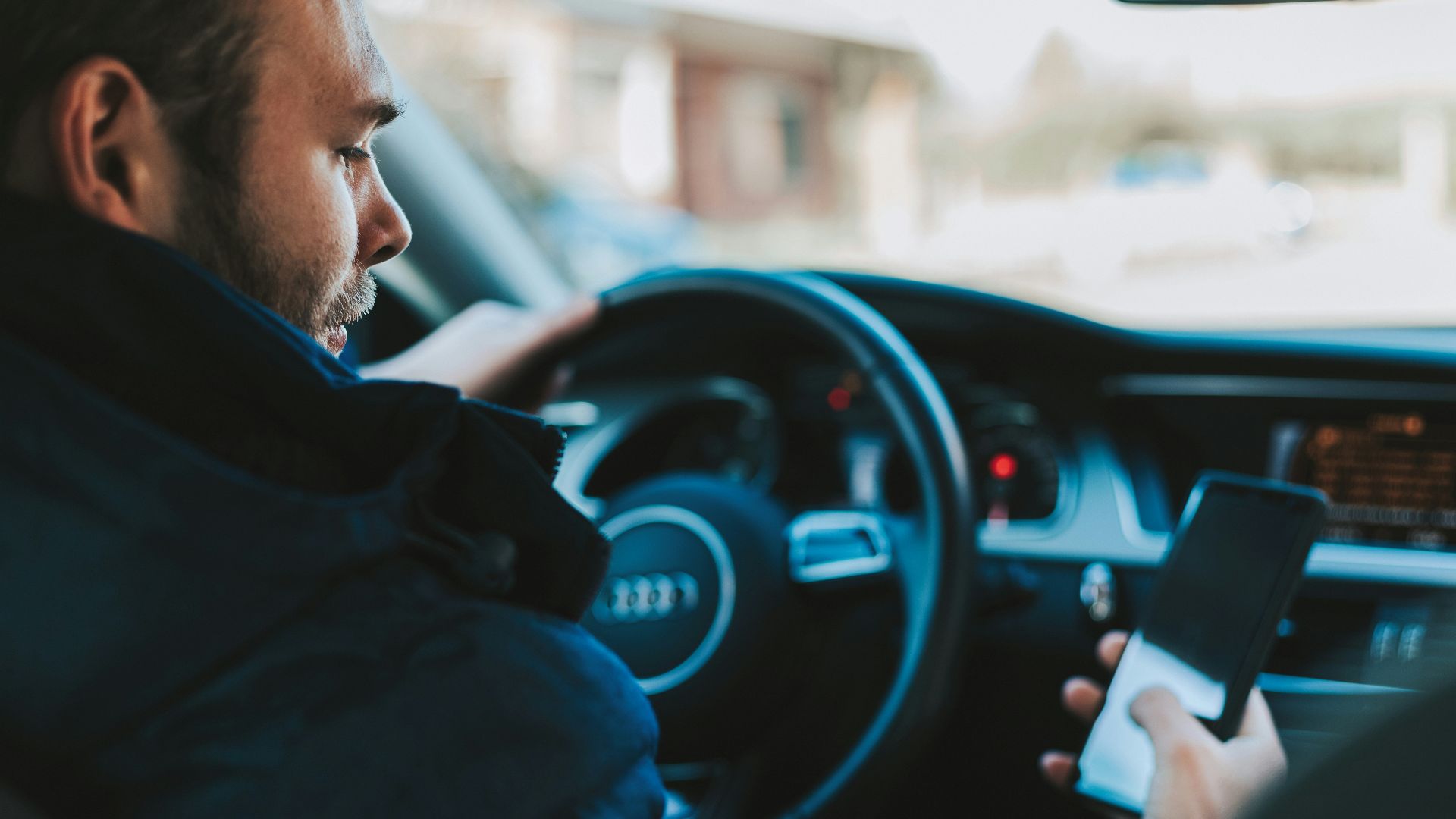 man holding black smartphone