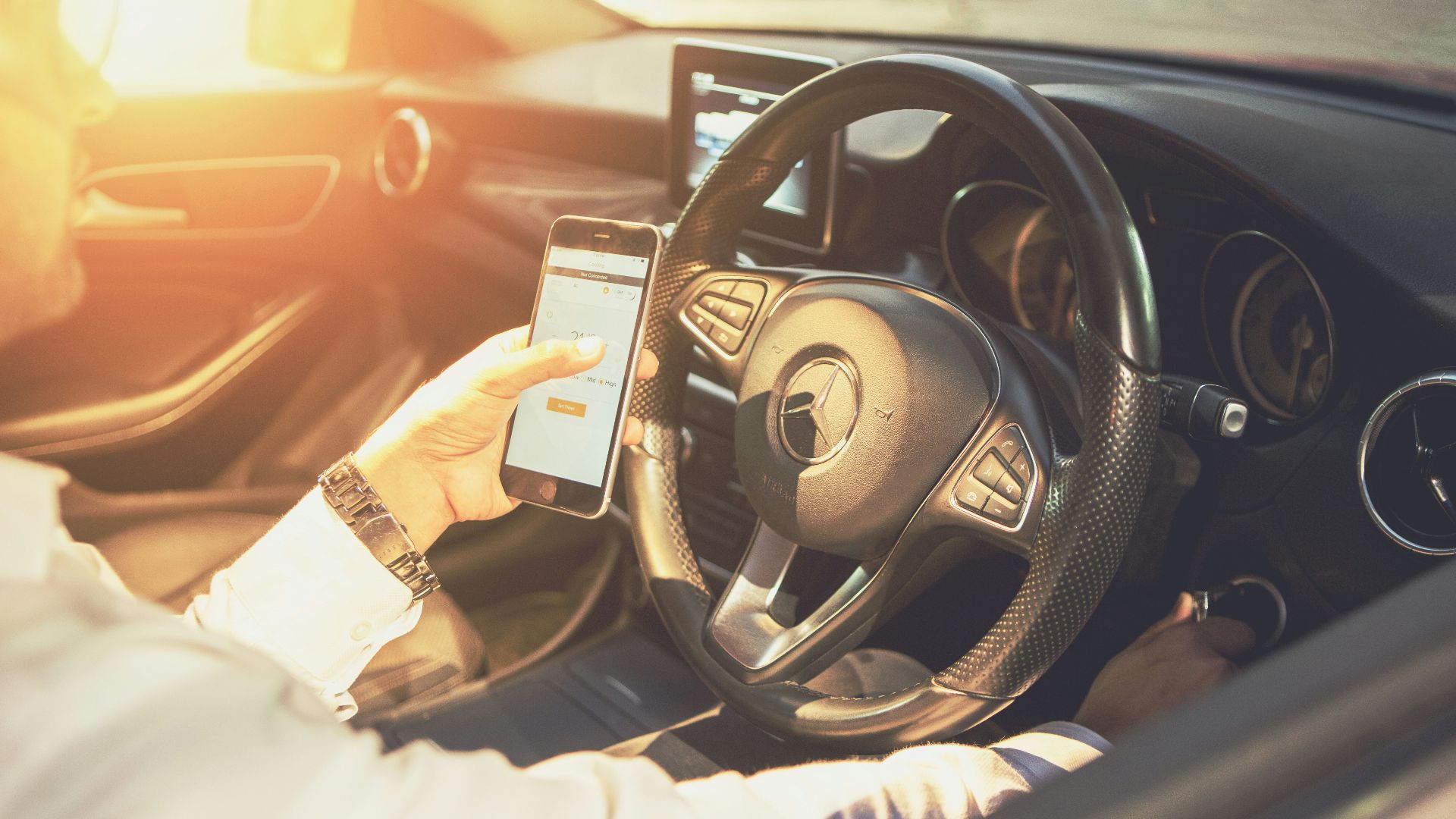 person holding black and silver steering wheel