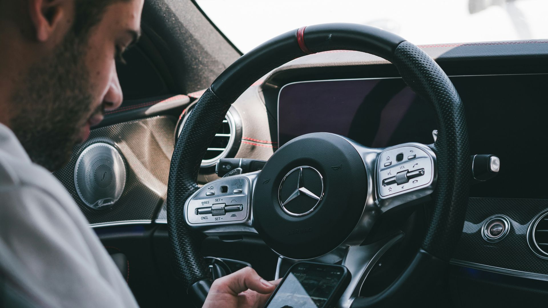 man in white dress shirt driving car during daytime