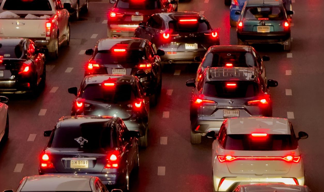 Heavy traffic jam in downtown Bangkok at twilight with numerous cars