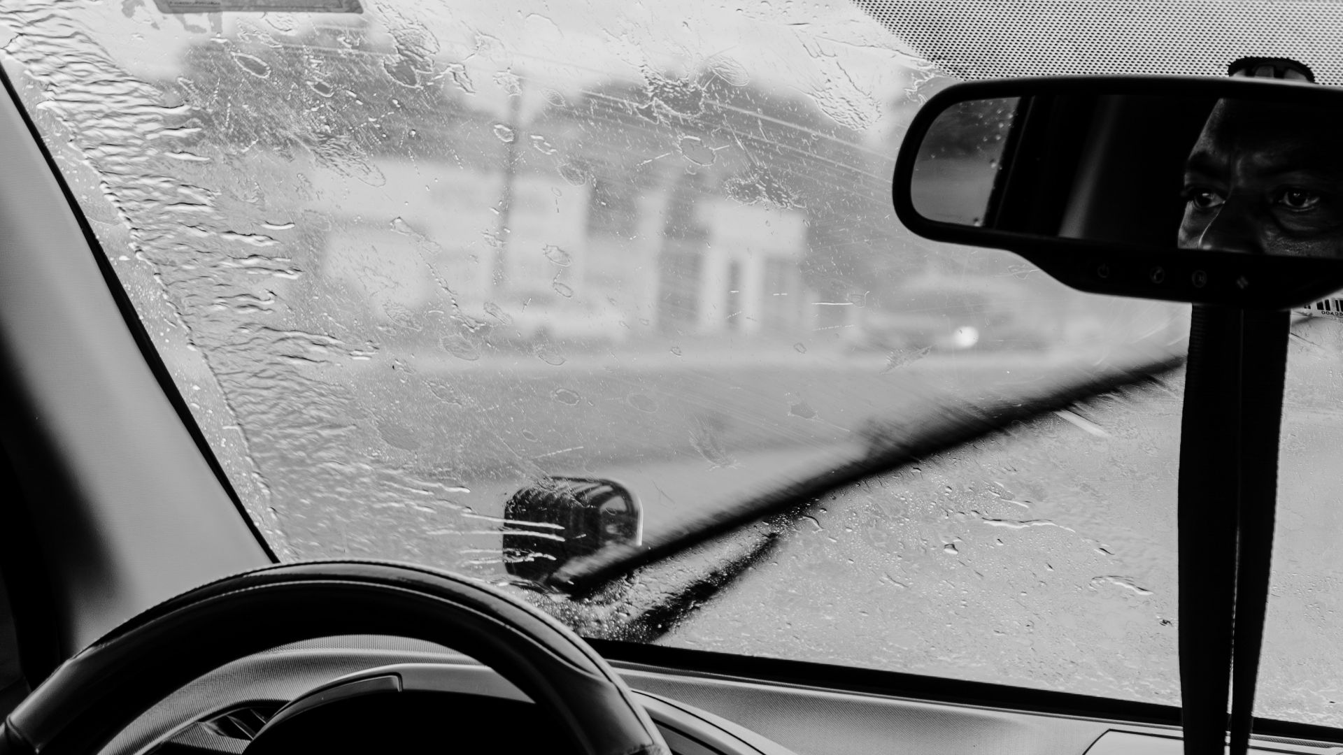 Windshield wipers clearing rain from a car window