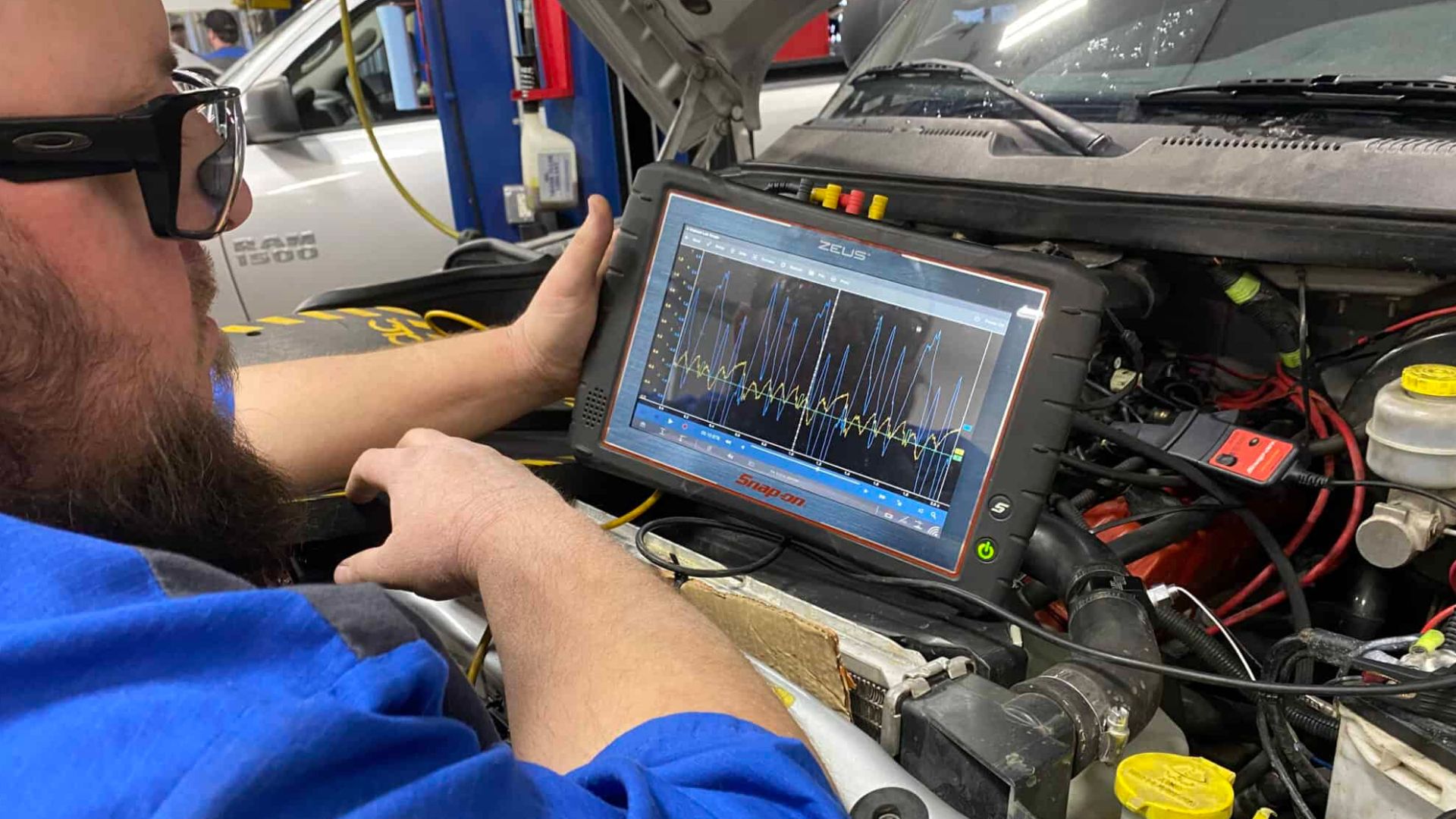 A man is diagnosing a electronic vehicle system
