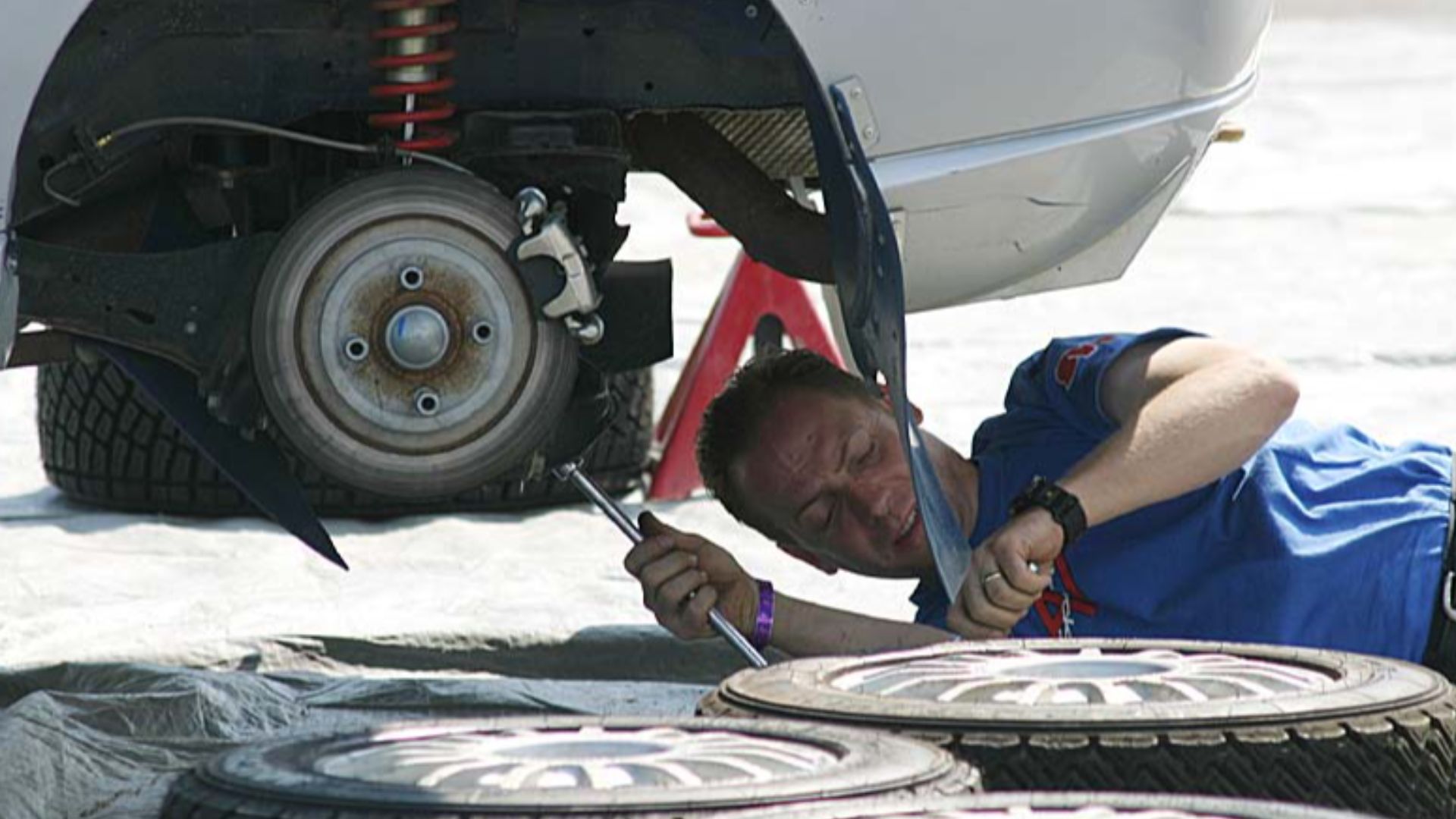 An auto mechanic works on a rally car at the 2003 Ojibwe Rally in Bemidji, MN.