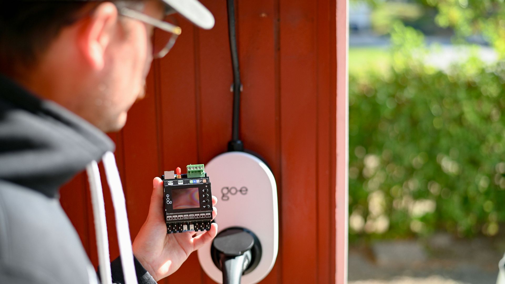 Man is examining an electric vehicle charger