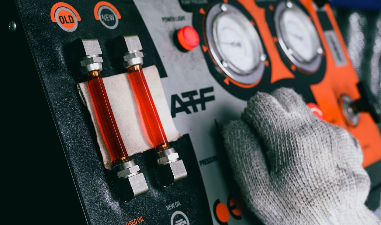 Automatic transmission fluid (ATF) flushing service in garage shop. 
