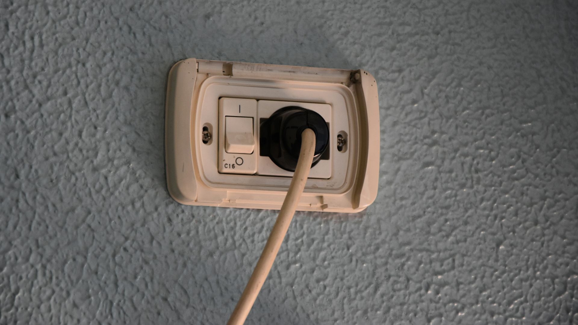 a light switch with a wooden stick sticking out of it
