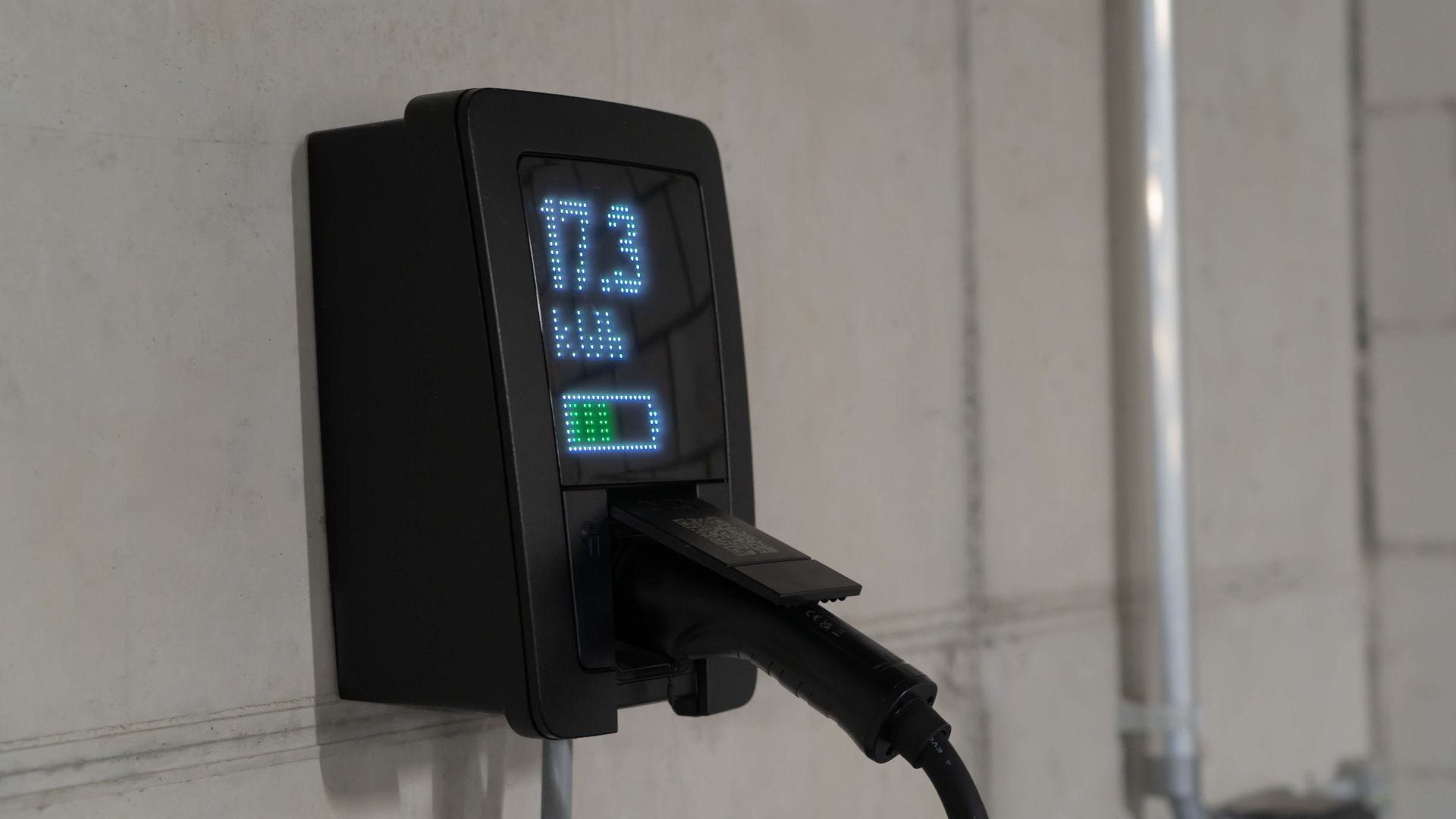 Detailed view of an electric vehicle charging station indoors, showcasing charging technology.